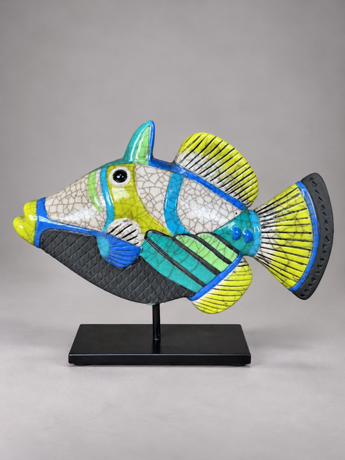 Angled view of one-of-a-kind Picasso raku fish sculpture showing turquoise and lime green geometric designs, sculpted fins and handmade ceramic details.