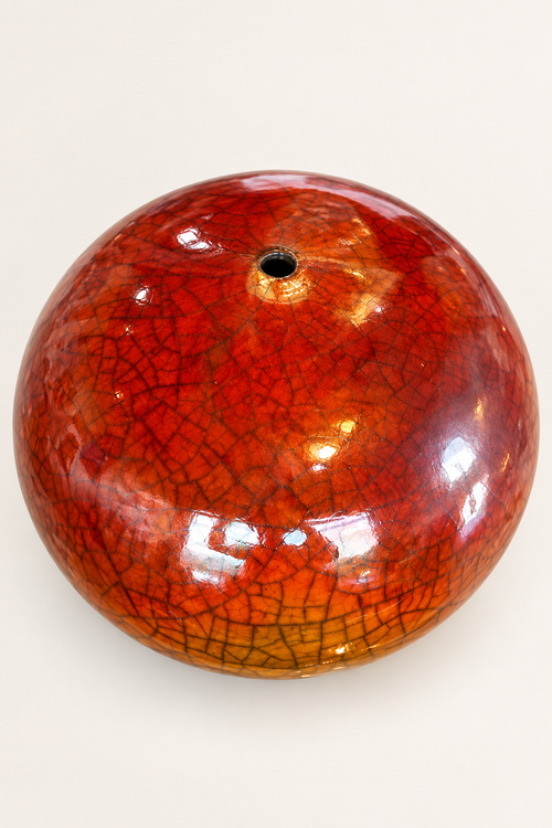 Top view of one-of-a-kind handmade round raku ceramic vase with ferric chloride crackle finish