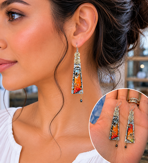 Orange sterling silver statement earrings shown on model ear for size reference.