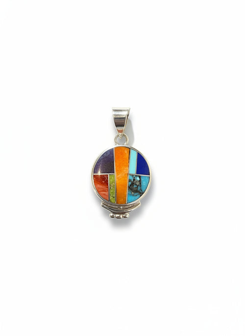 Close-up of a handmade Navajo sterling silver pendant showcasing Orange Spiny Oyster, Turquoise, Lapis, Sugilite and Gaspeite stone inlay.