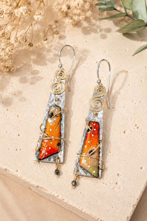 Orange statement earrings in sterling silver featuring vibrant orange accents and handcrafted design.