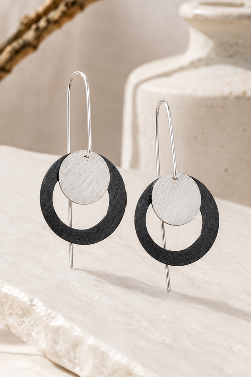 Oxidized sterling silver eclipse earrings with polished silver discs and long ear wires