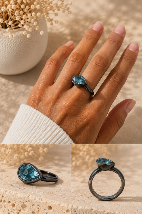 Side profile of a handmade pear-shaped Blue Topaz ring highlighting the bezel setting and polished oxidized sterling silver band.