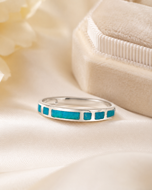 Petite chrysocolla sterling silver ring displayed in a luxury jewelry setting
