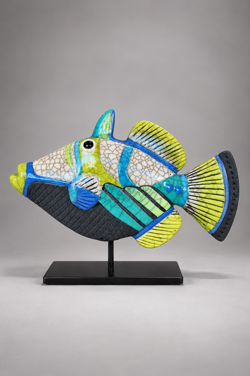 Handmade Picasso raku ceramic fish sculpture featuring turquoise, blue, lime green and yellow geometric patterns with crackle glaze on a black metal stand.