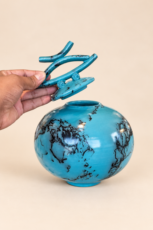 Sculptural turquoise raku pot with decorative lid and distinctive horsehair firing lines
