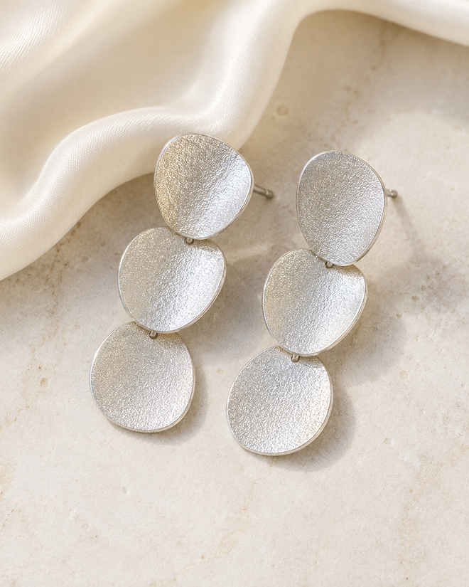 Sterling silver curved disc drop post earrings with textured linked discs