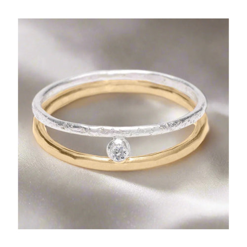 Sterling silver and gold orbit ring with bezel set cubic zirconia
