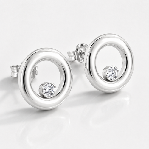 Handcrafted sterling silver open circle stud earrings featuring brilliant 4 mm white cubic zirconia, polished finish, and a contemporary minimalist design for everyday elegance.