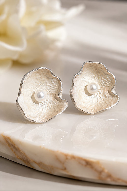 Elegant sterling silver floral stud earrings with genuine freshwater pearls worn by a model, perfect for weddings, anniversaries, birthdays, and everyday luxury.