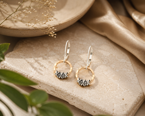 Handcrafted 14kt gold-filled circle earrings wrapped with oxidized sterling silver and sterling leverback hooks