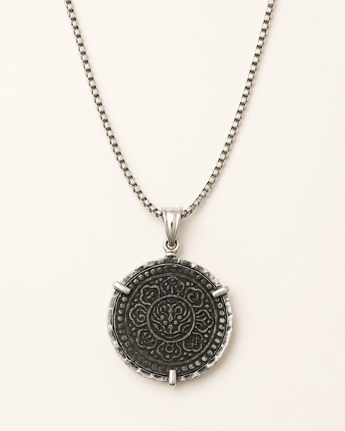 Reversible Tibetan Ga-Den Tangka coin necklace showing detailed symbolic design