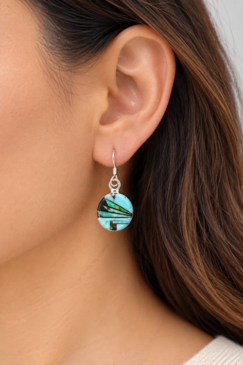 Model wearing petite round turquoise inlay earrings in sterling silver, featuring a colorful geometric design with Golden Hills turquoise and natural gemstones.