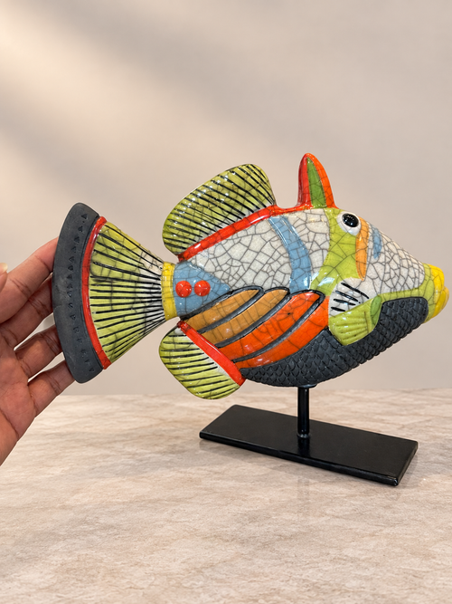Opposite side of orange and lime green Raku Picasso fish sculpture showing handmade crackle glaze and ceramic patterns