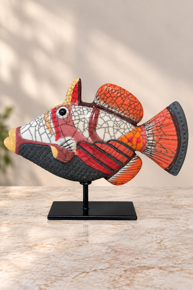 Opposite side of coral red Raku ceramic fish sculpture showing handmade patterns and distinctive crackle glaze