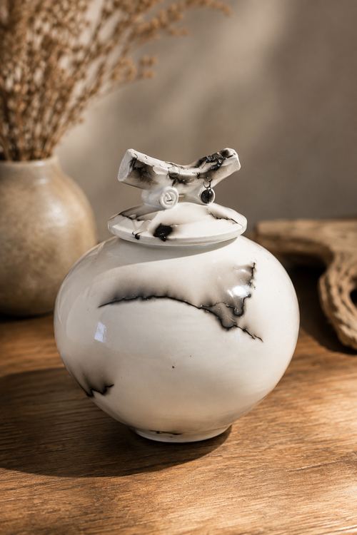 White and black horsehair pottery with sculptural ceramic lid