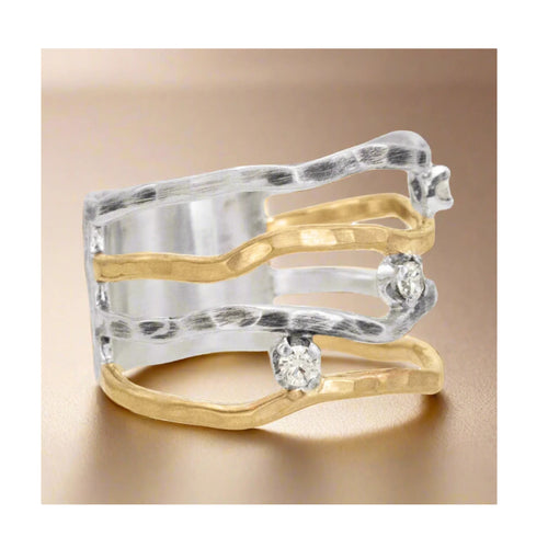 Close-up of handmade wave ring with white zirconia stones