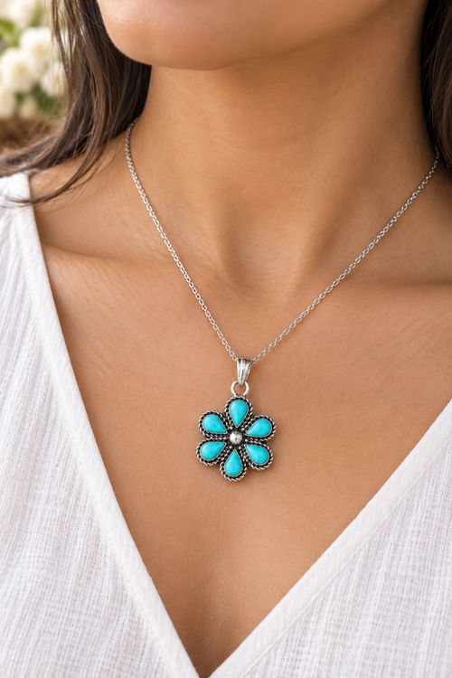 Zuni Kingman turquoise flower necklace in sterling silver shown worn on the neck