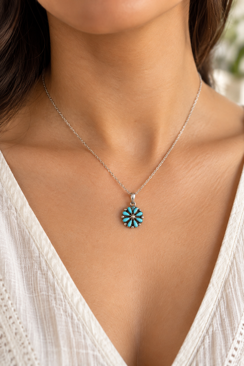 Zuni Kingman turquoise flower pendant necklace shown on neck, petite sterling silver Native American jewelry